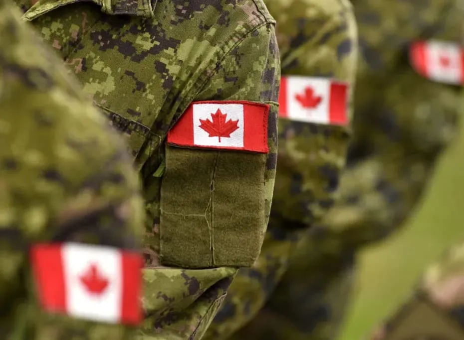 Canadian Armed Forces members in uniform with Canadian flag patches